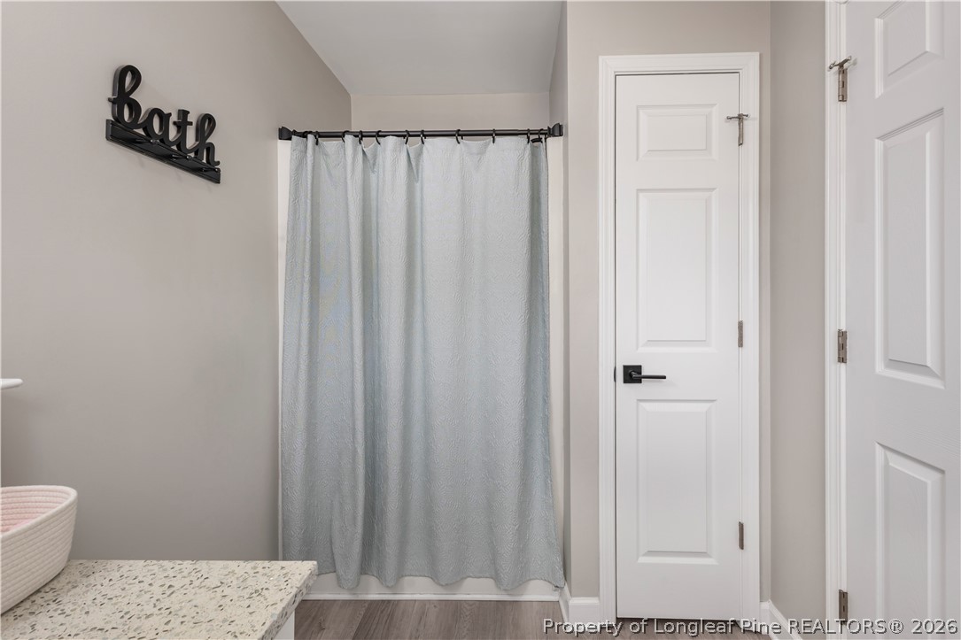 253 Farmstead Court Rockingham, NC 28379 - Photo 7 of 25 a bathroom with a shower curtain and toilet