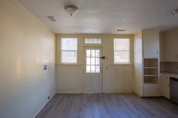 a view of an empty room with a fireplace and a window