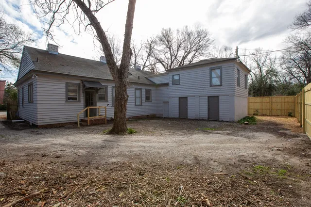 a view of a house with a yard and garage