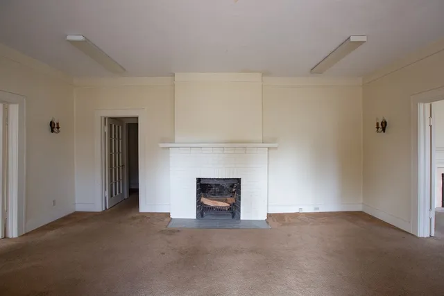 a room with a fireplace and a ceiling fan