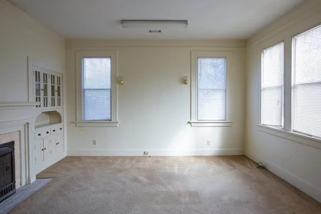 an empty room that has a mirror