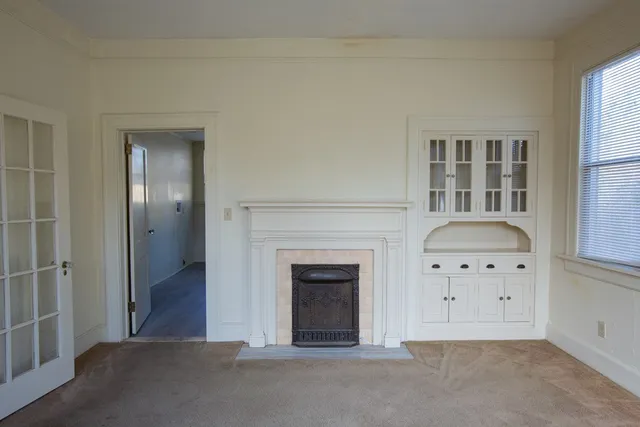 a kitchen with wooden floors and white stainless steel appliances