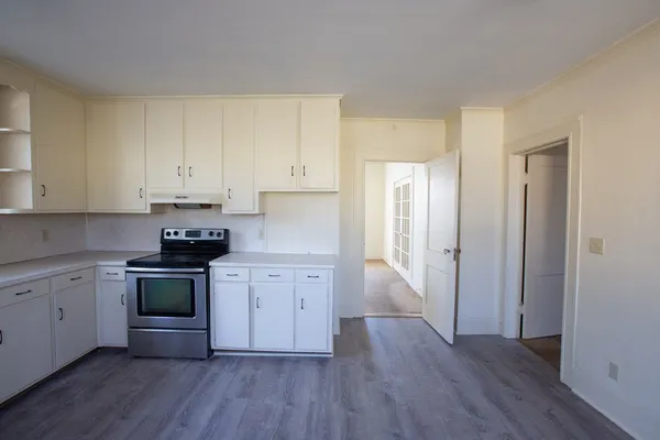 a kitchen with sink a microwave and cabinets