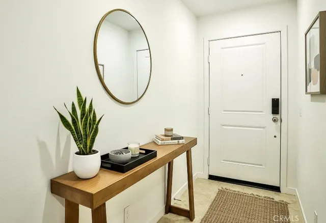 a bathroom with a sink a mirror and a potted plant