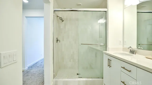 a bathroom with a shower and a sink