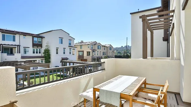 a balcony view with a table and chairs