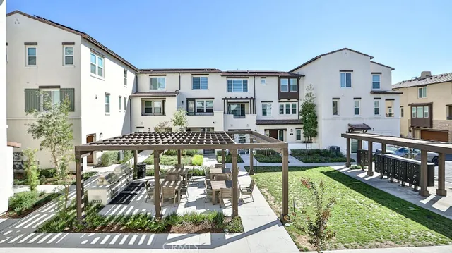 a backyard of a house with lots of green space and glass windows