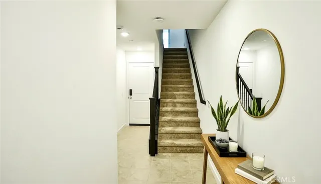 an entryway in wooden floor with staircase