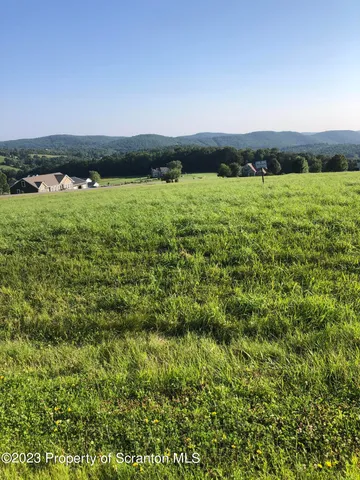 a view of a lake with houses in the back