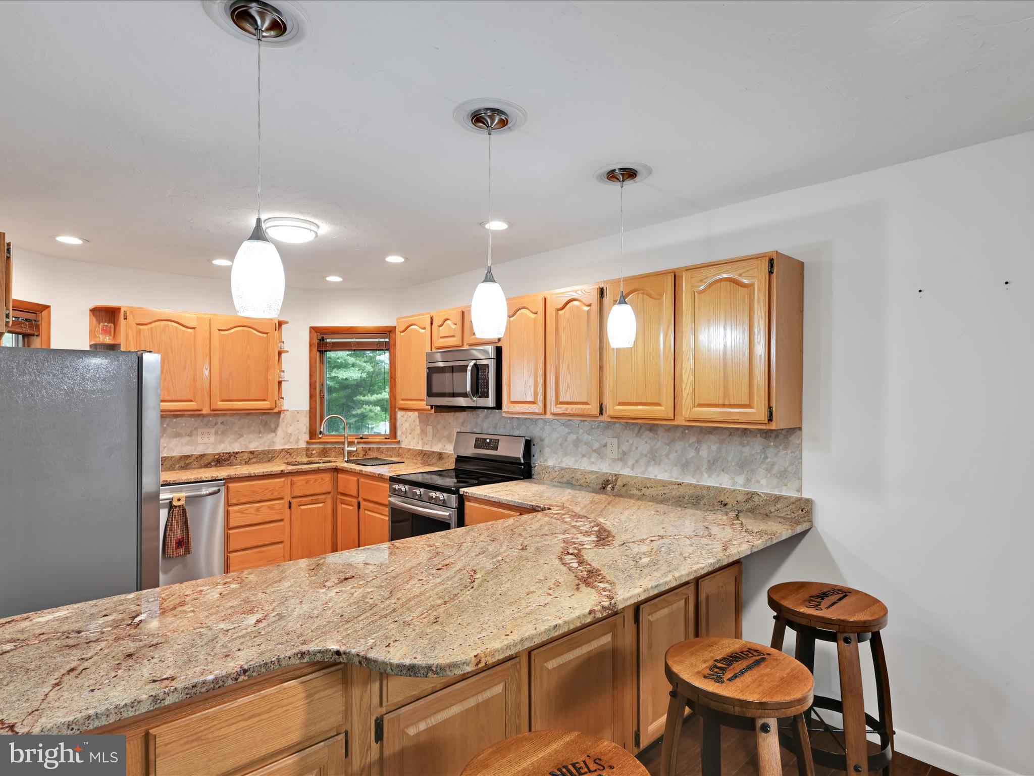 5150 Chestnut Grove Road Spring Grove, PA 17362 - Photo 11 of 56 a kitchen with a table chairs sink and refrigerator