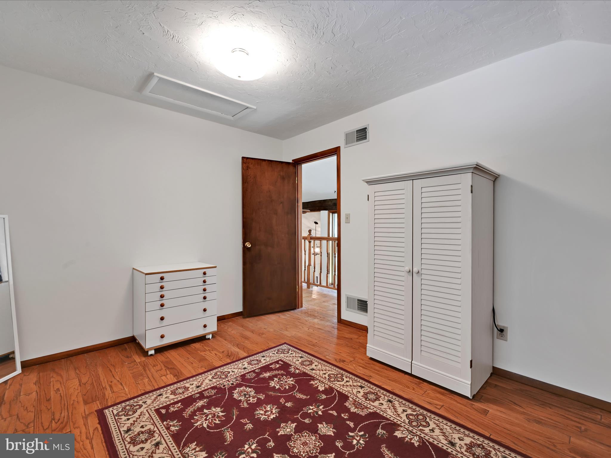 5150 Chestnut Grove Road Spring Grove, PA 17362 - Photo 23 of 56 a view of an empty room with wooden floor and closet