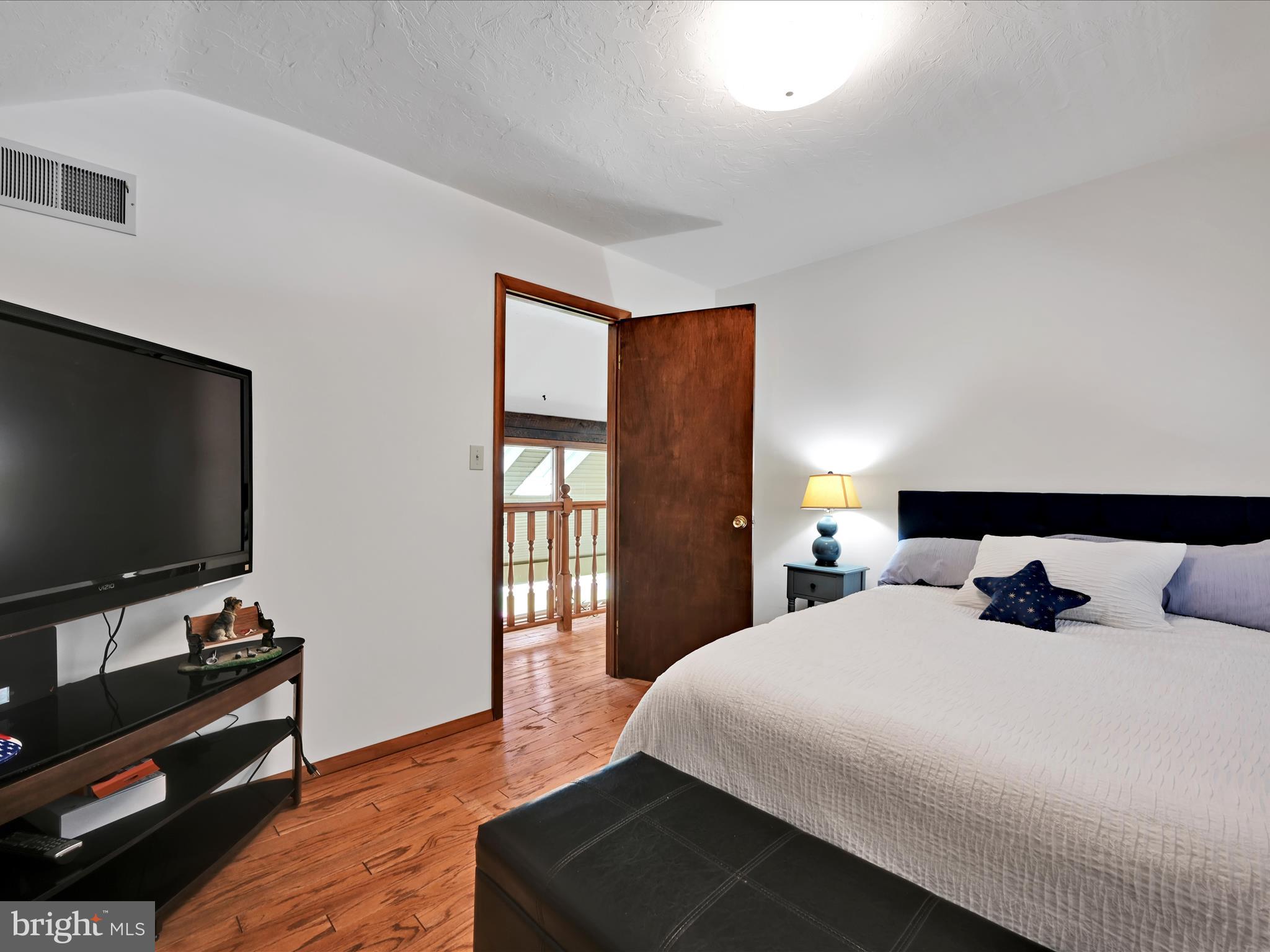 5150 Chestnut Grove Road Spring Grove, PA 17362 - Photo 25 of 56 a bedroom with a bed and a flat screen tv