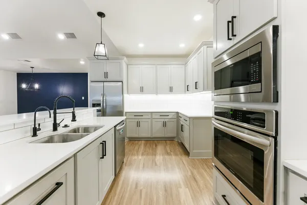 a kitchen with a sink stainless steel appliances and cabinets