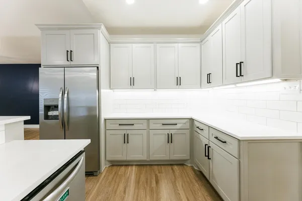 a kitchen with a sink appliances and cabinets