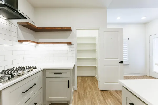 a kitchen with a stove and a refrigerator
