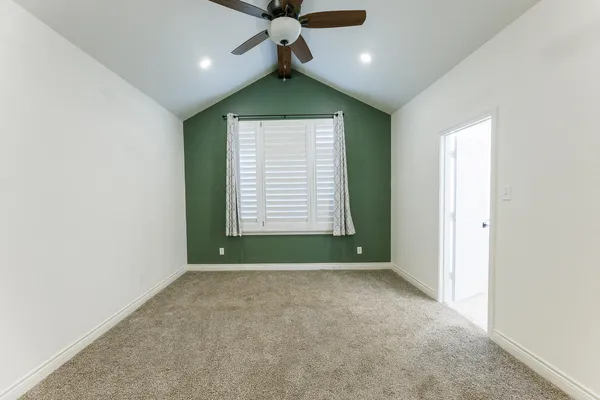 a view of room with window and ceiling fan