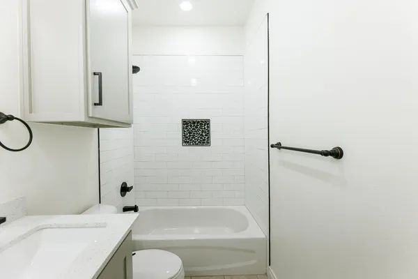 a bathroom with a shower a bath tub and a shower