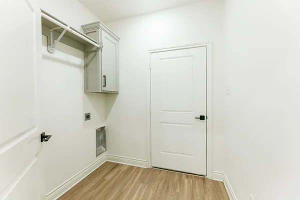 a view of walk in closet with wooden floor