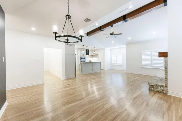 a view of a kitchen with a sink and wooden floor