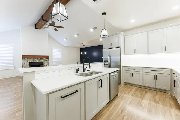 a kitchen with a sink stove and refrigerator