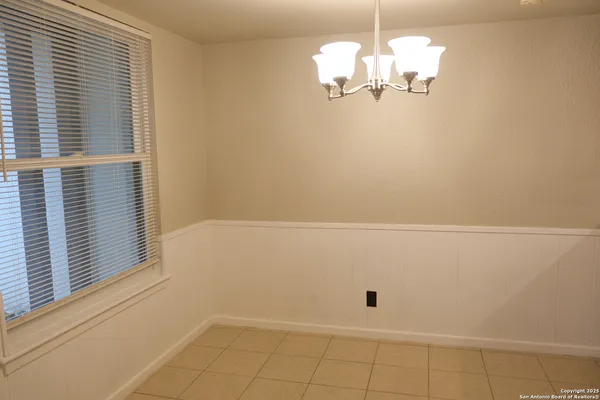 a view of a hardwood floor and chandelier in a room