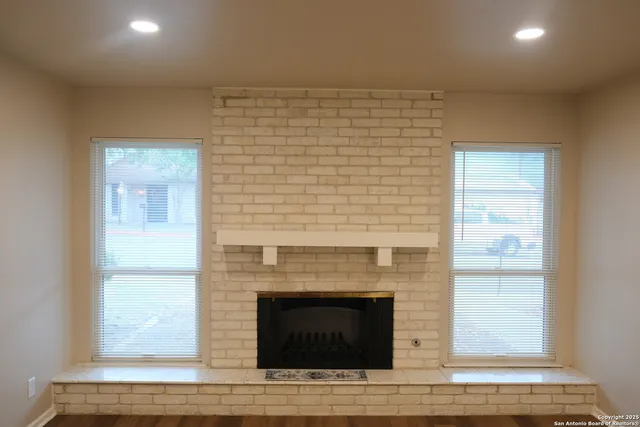 a view of a livingroom with a fireplace and window