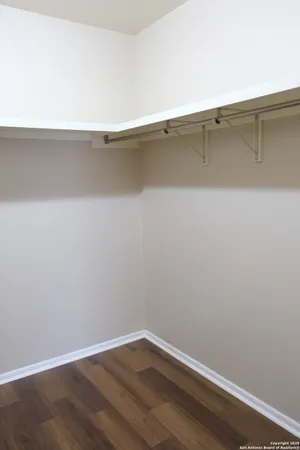 a view of a room with wooden floor