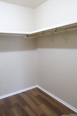 a view of a room with wooden floor