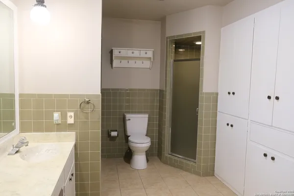 a bathroom with a toilet sink and shower