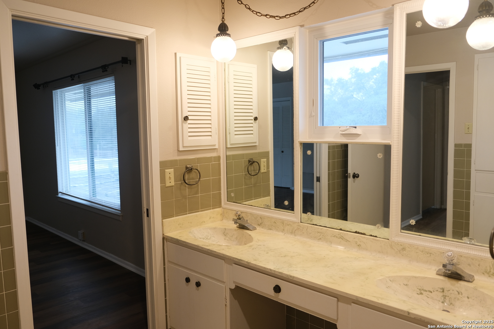 393 Fenwick Drive Windcrest, TX 78239 - Photo 31 of 42 a bathroom with a granite countertop sink and a mirror