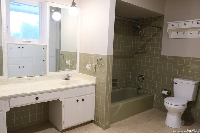 a bathroom with a sink toilet tub and shower