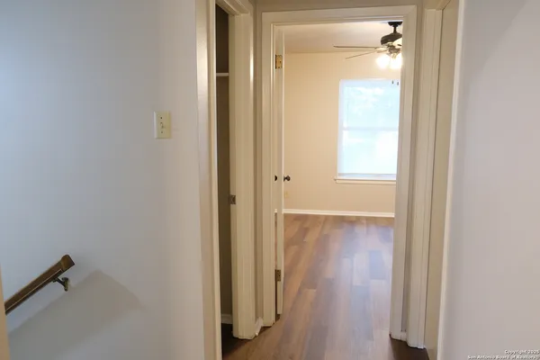 a view of a hallway with wooden floor
