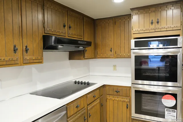 a kitchen with granite countertop cabinets and steel stainless steel appliances