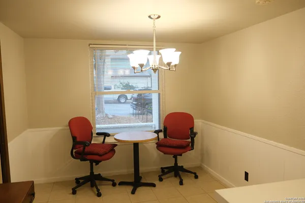 a dining room with furniture and a chandelier