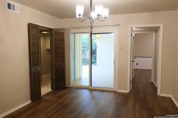 a view of empty room with wooden floor