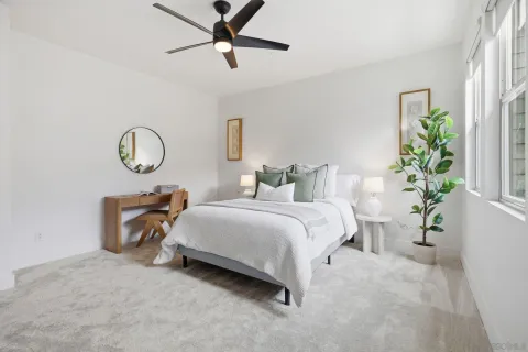 a bedroom with bed and a potted plant