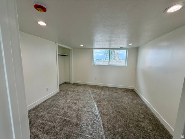 2865 North 3250 W Road Sutherland, UT 84624 - Photo 15 of 28 Spacious room featuring neutral carpeting, white walls, recessed lighting, and a window with a natural backdrop