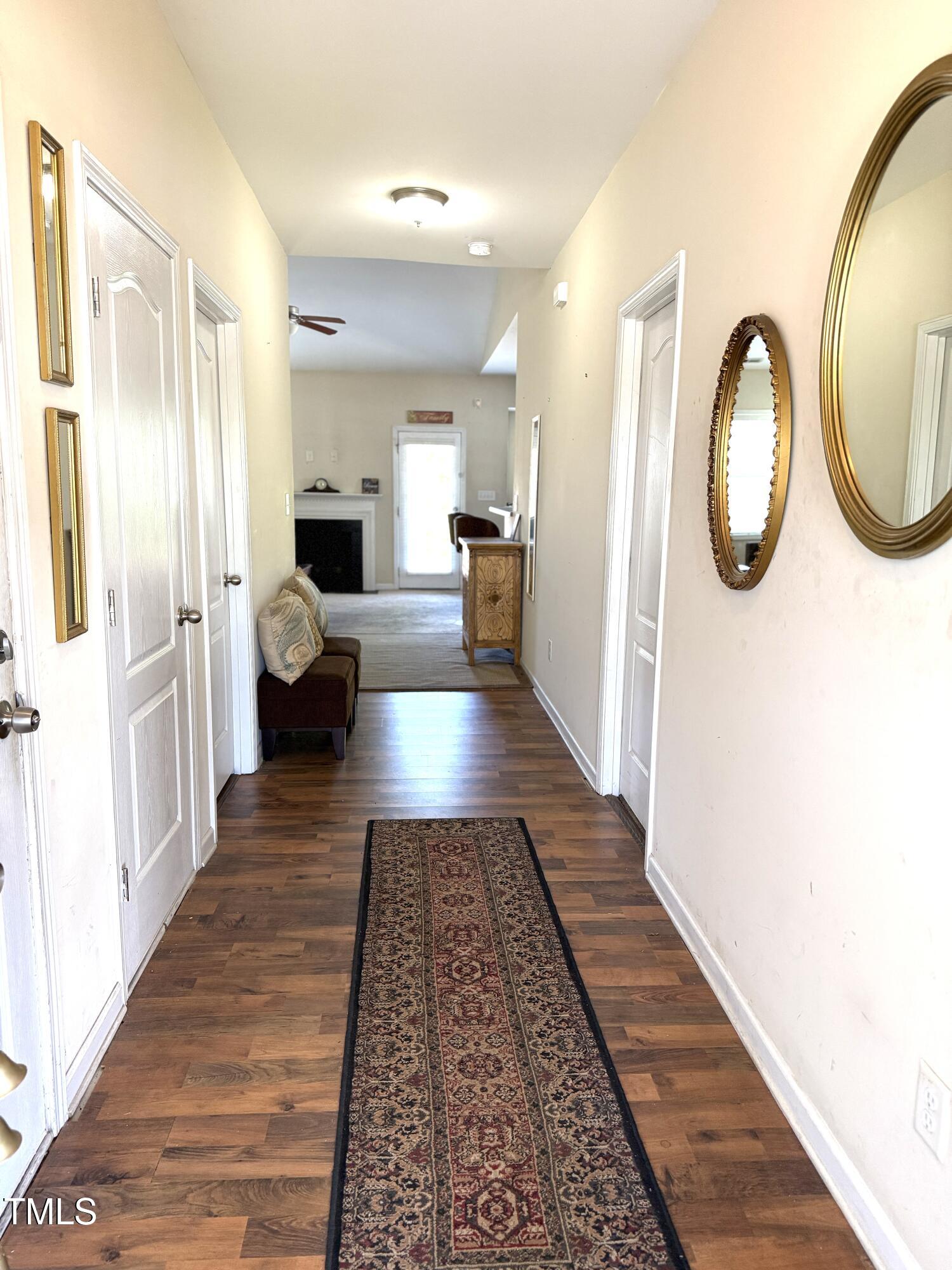 6320 Slopeside Court Raleigh, NC 27610 - Photo 5 of 24 a view of a hallway with furniture and a rug