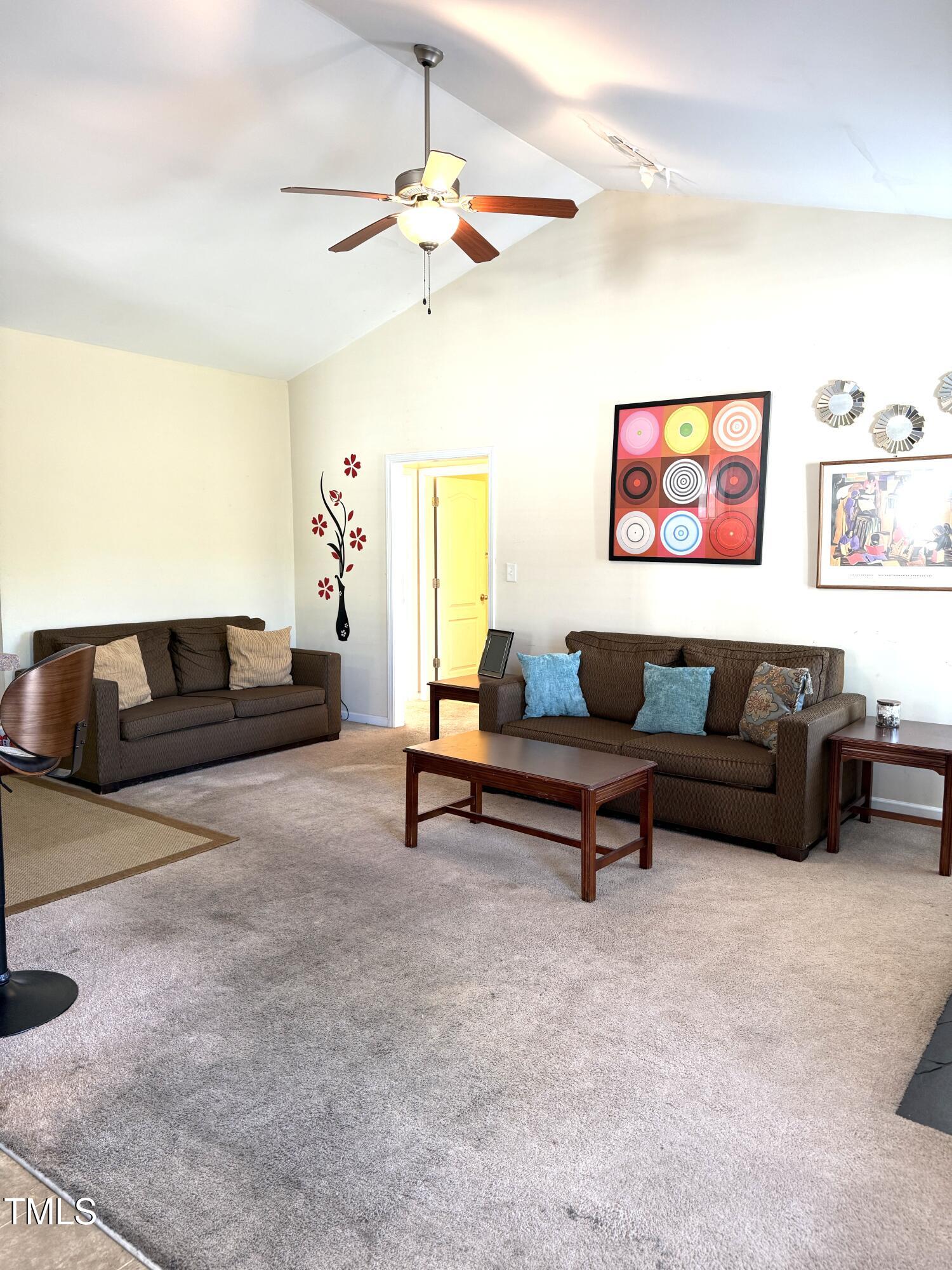 6320 Slopeside Court Raleigh, NC 27610 - Photo 7 of 24 a living room with furniture and a ceiling fan