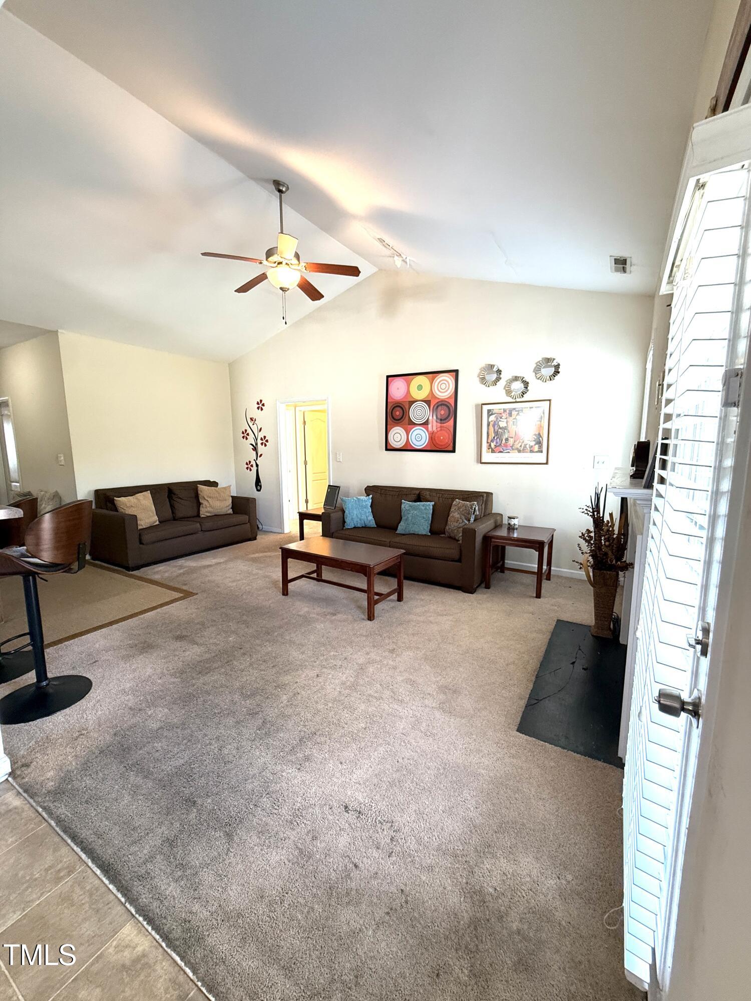 6320 Slopeside Court Raleigh, NC 27610 - Photo 8 of 24 a living room with furniture and a chandelier