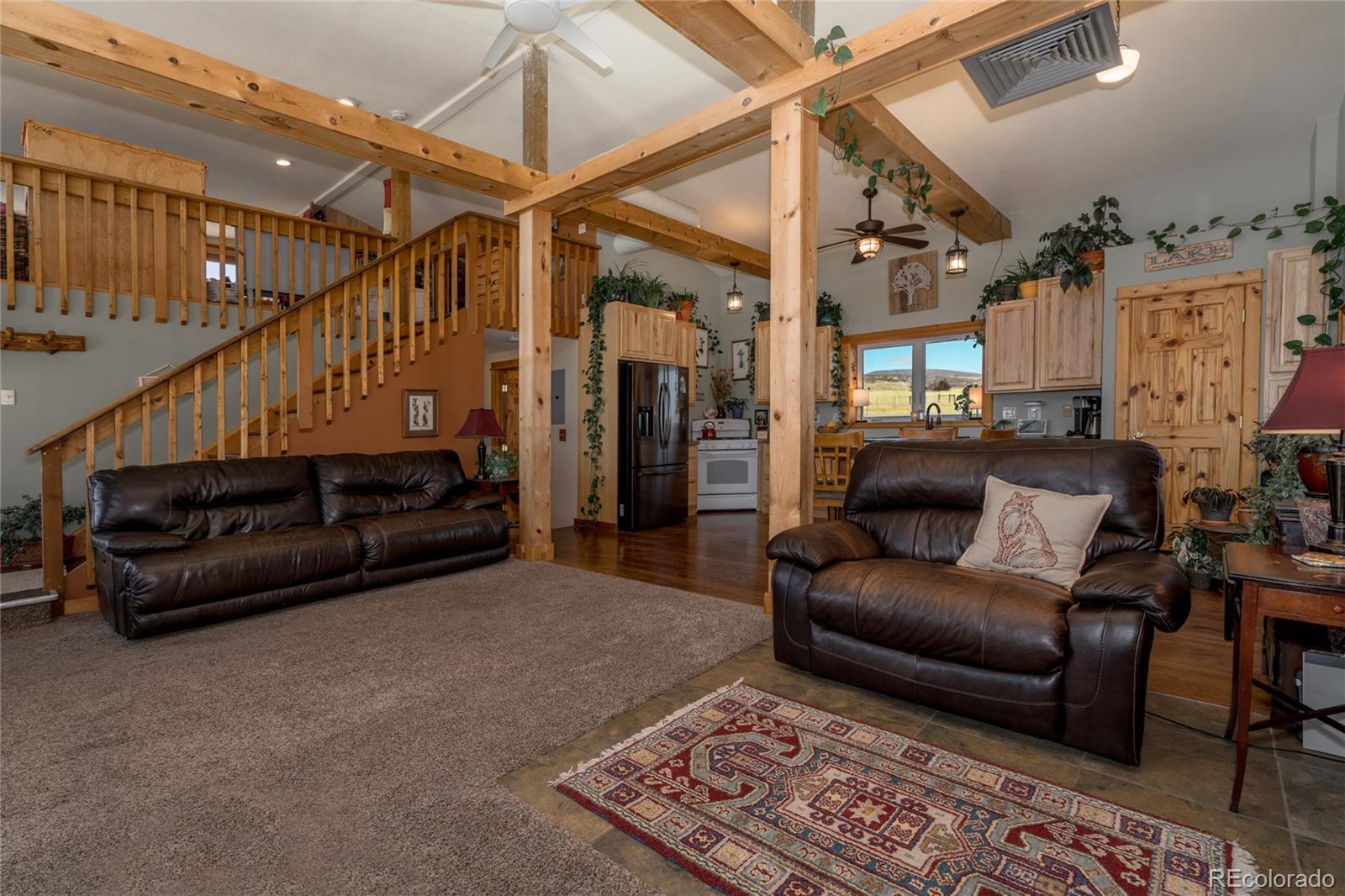 10320 Miners Lake Road Fort Collins, CO 80524 - Photo 1 of 39 a living room with furniture and a rug