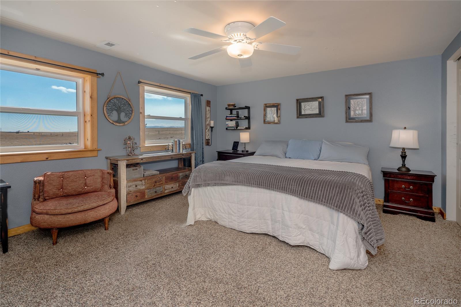 10320 Miners Lake Road Fort Collins, CO 80524 - Photo 11 of 39 a spacious bedroom with a bed and a couch