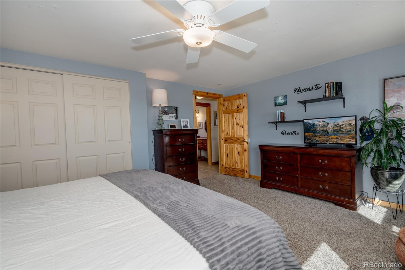 10320 Miners Lake Road Fort Collins, CO 80524 - Photo 12 of 39 a bedroom with a bed and a dresser in it