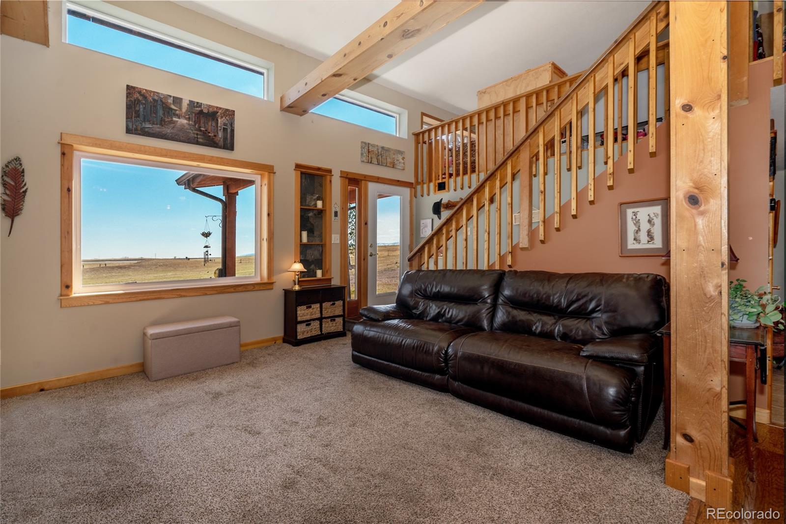 10320 Miners Lake Road Fort Collins, CO 80524 - Photo 2 of 39 a living room with furniture and a wooden floor
