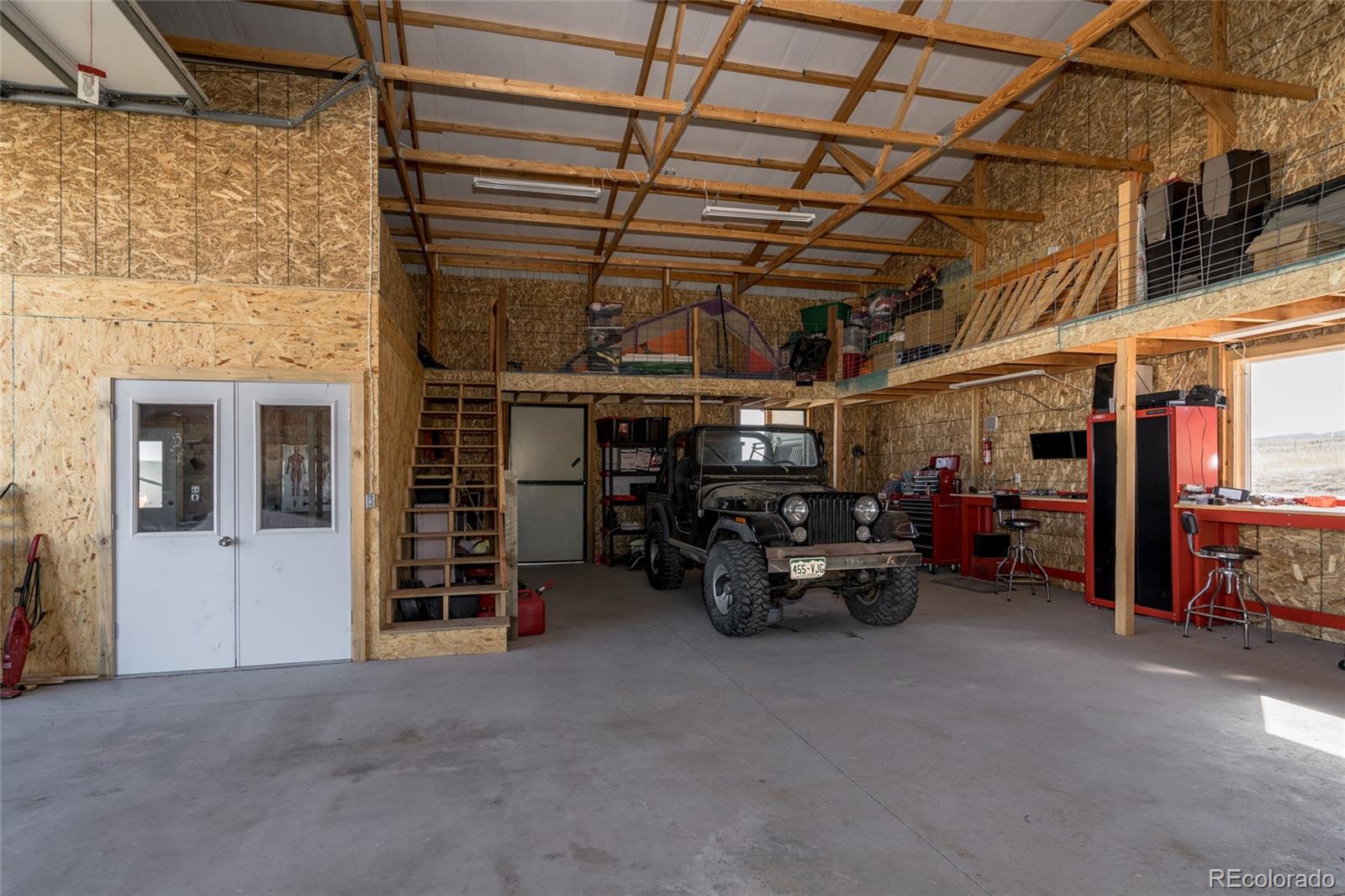 10320 Miners Lake Road Fort Collins, CO 80524 - Photo 25 of 39 a view of a garage with rack and furniture