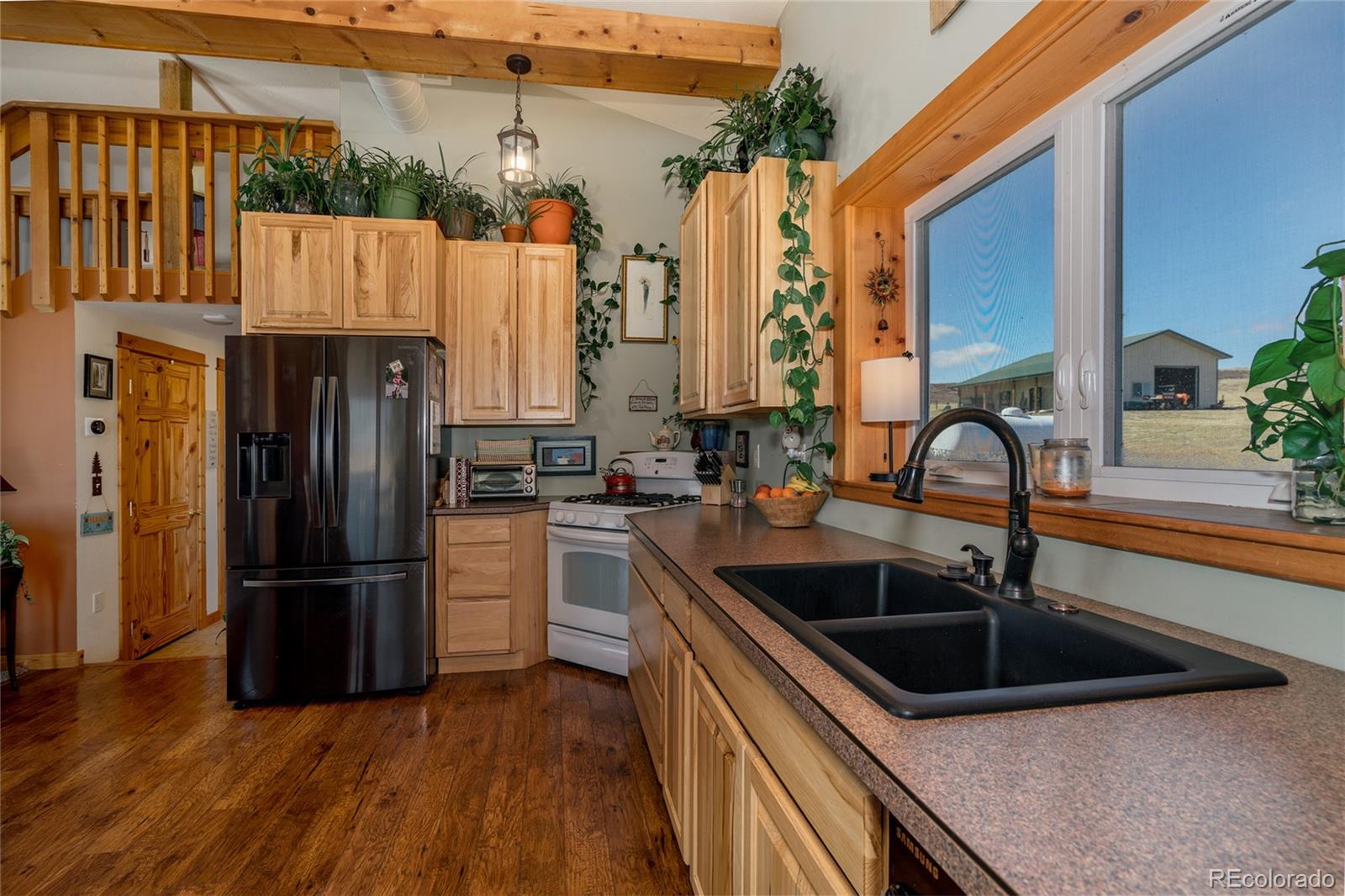 10320 Miners Lake Road Fort Collins, CO 80524 - Photo 3 of 39 a kitchen that has a refrigerator and a sink