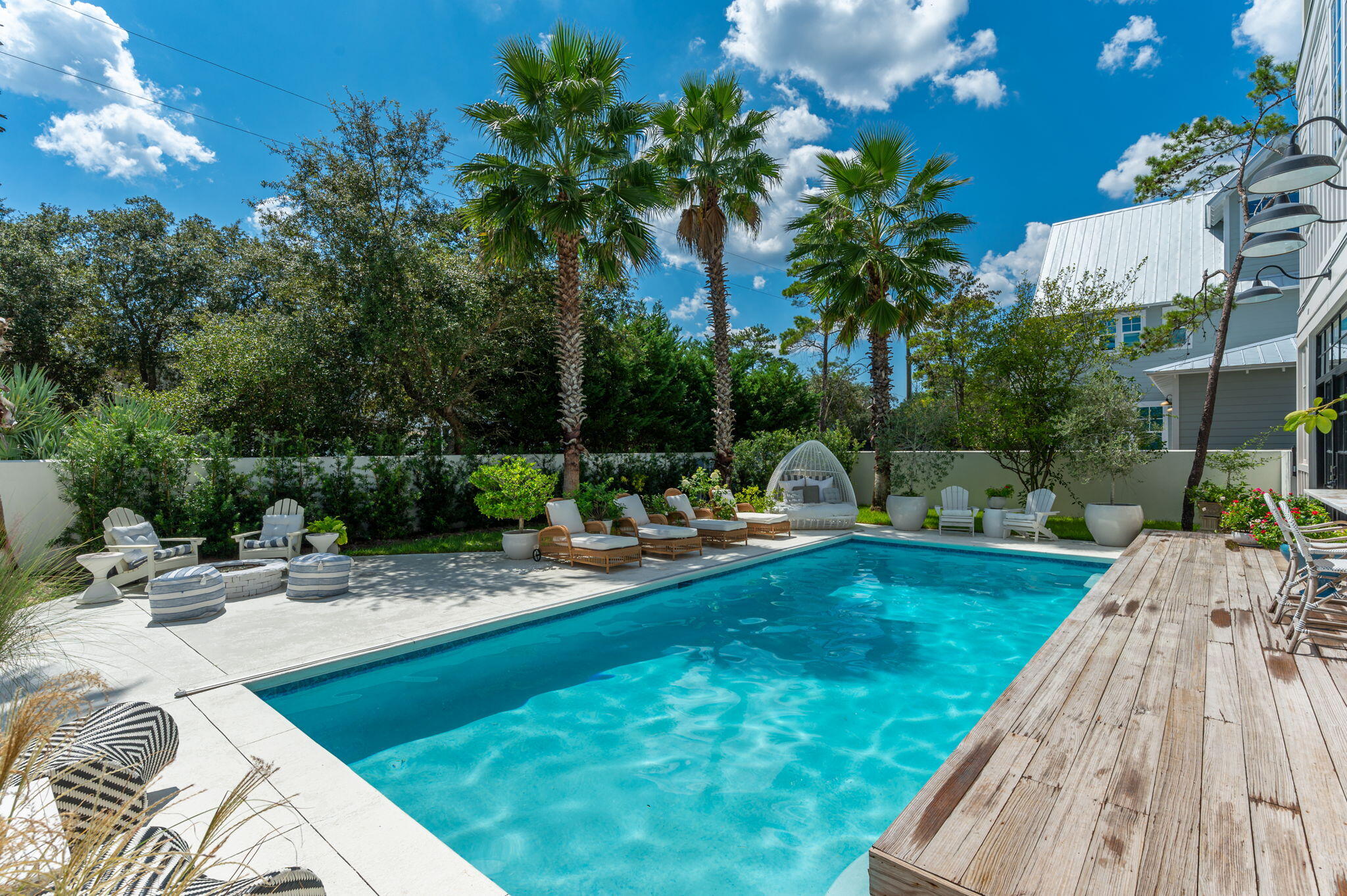 a view of a swimming pool with a patio and a garden