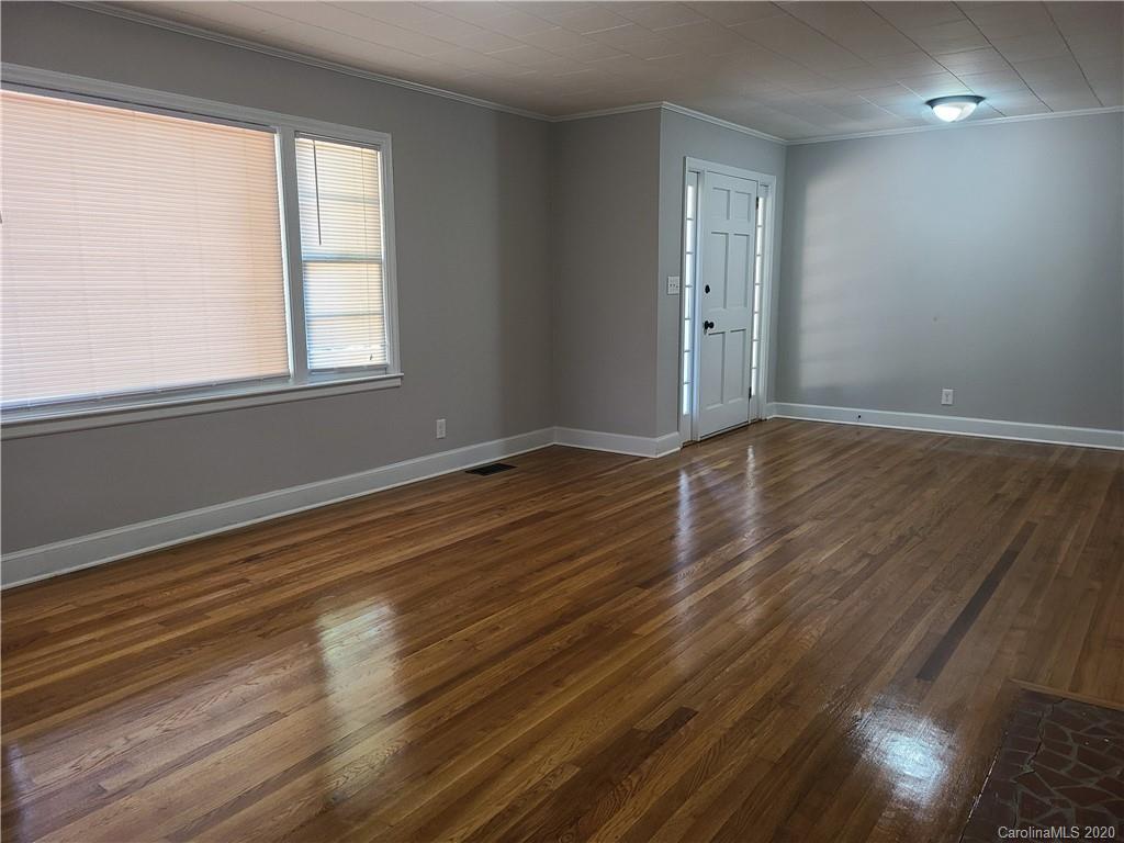 1820 Linwood Road Gastonia, NC 28052 - Photo 11 of 24 a view of an empty room with wooden floor and a window