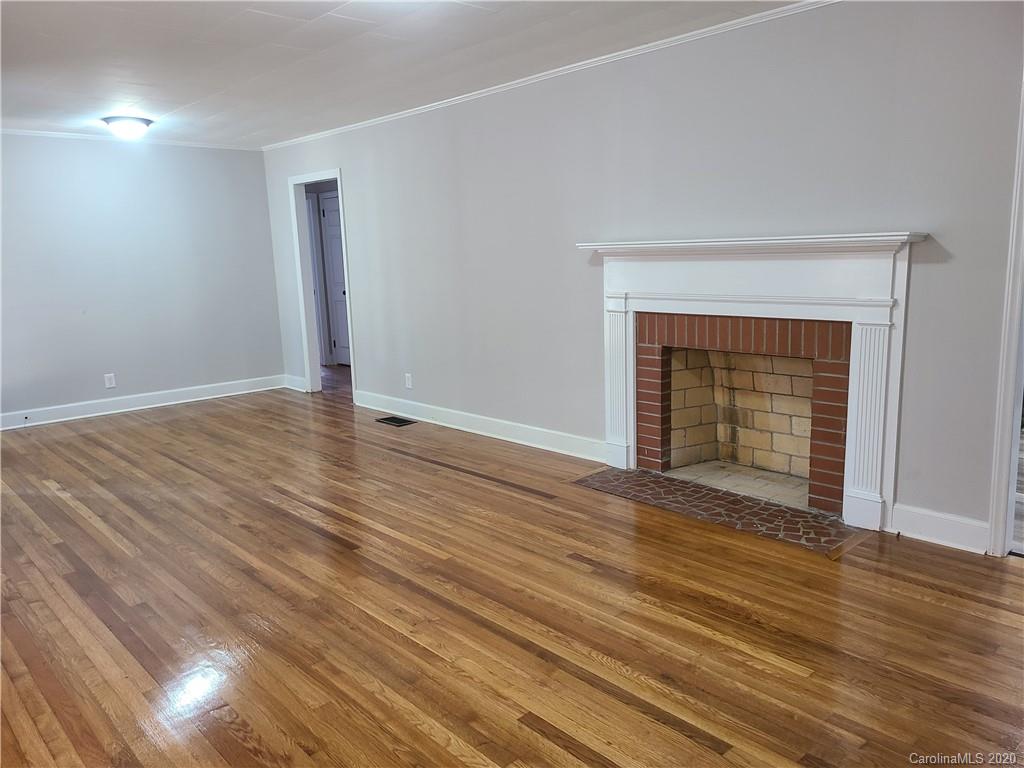 1820 Linwood Road Gastonia, NC 28052 - Photo 13 of 24 a view of an empty room with wooden floor and a window
