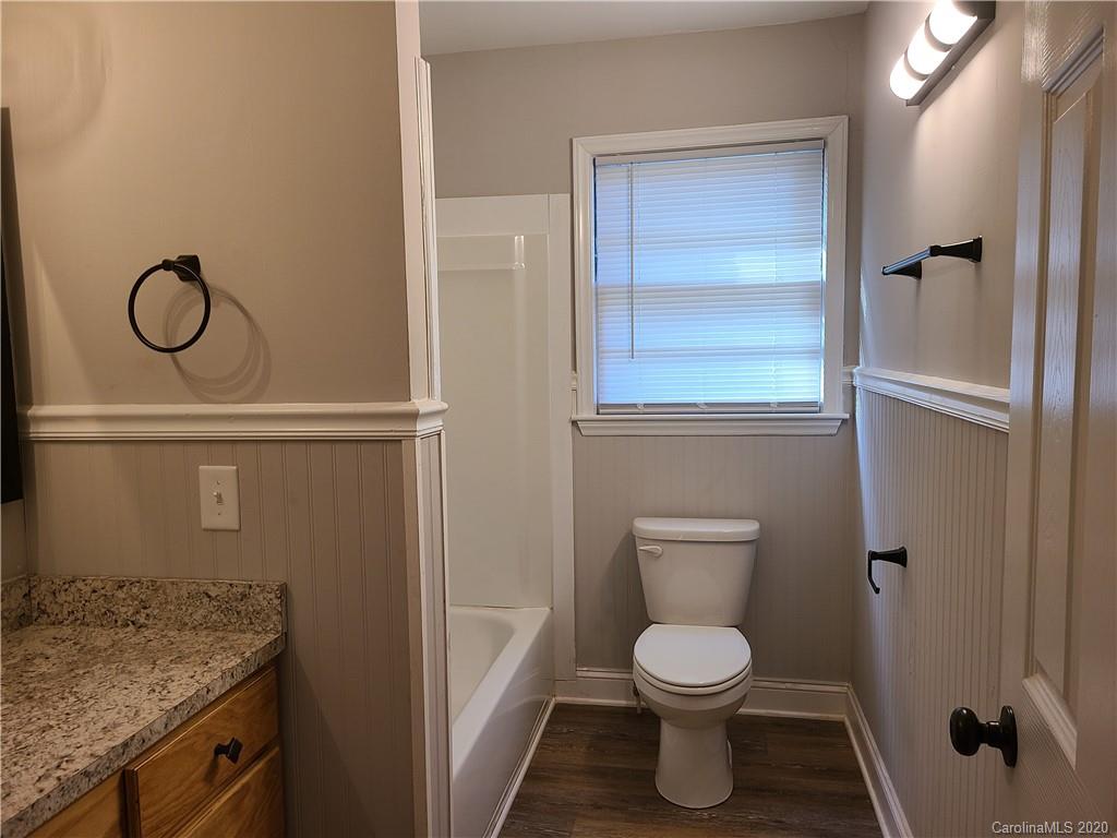 1820 Linwood Road Gastonia, NC 28052 - Photo 14 of 24 a bathroom with a granite countertop toilet and a sink